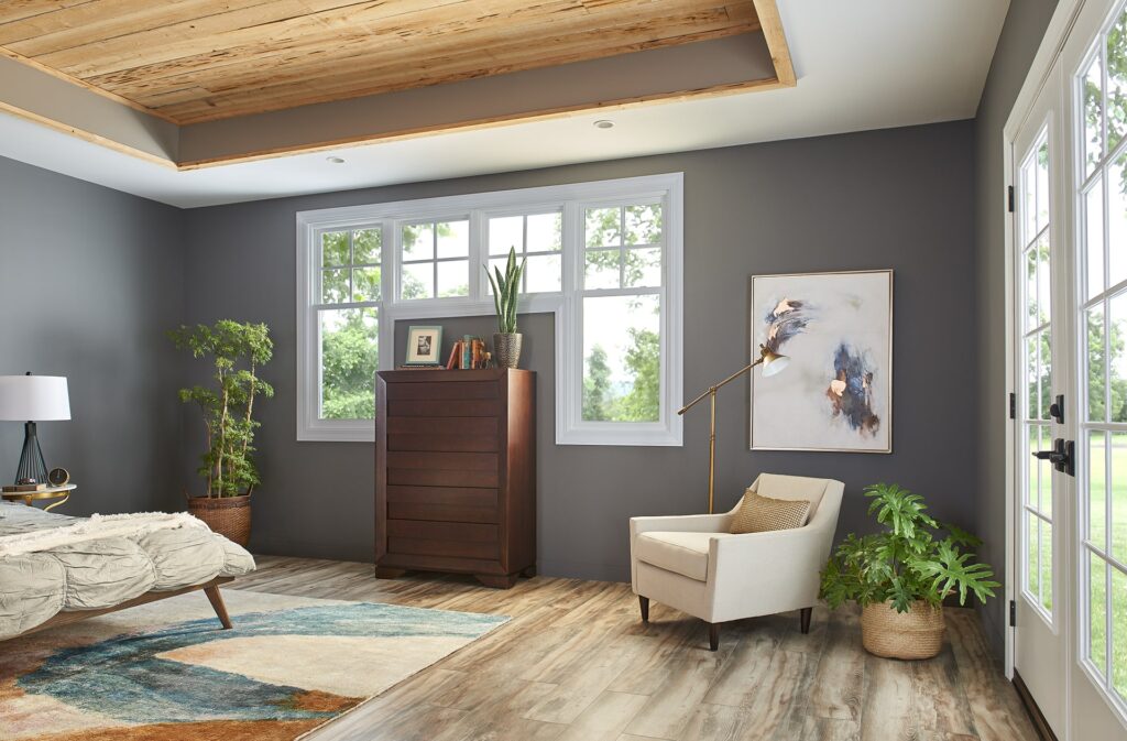 Gray bedroom with white French door and windows